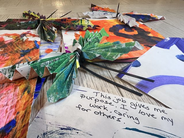 A group of paper butterflies with inspirational messages